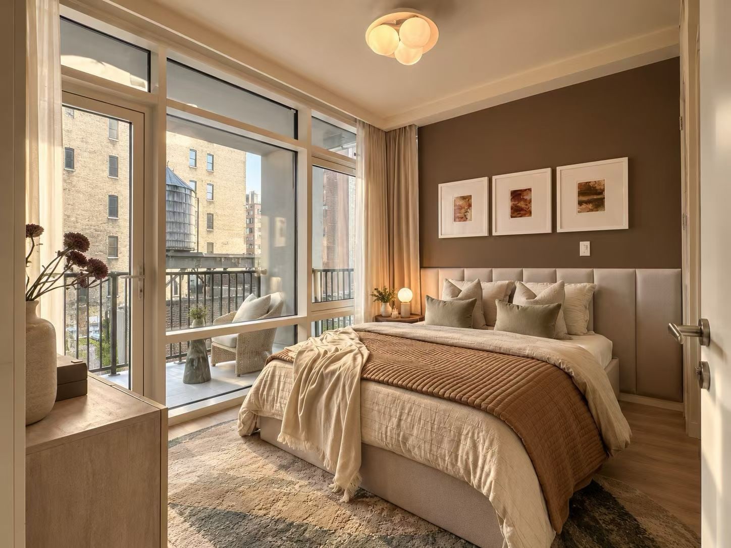 A calm bedroom with sliding doors leading to a private loggia